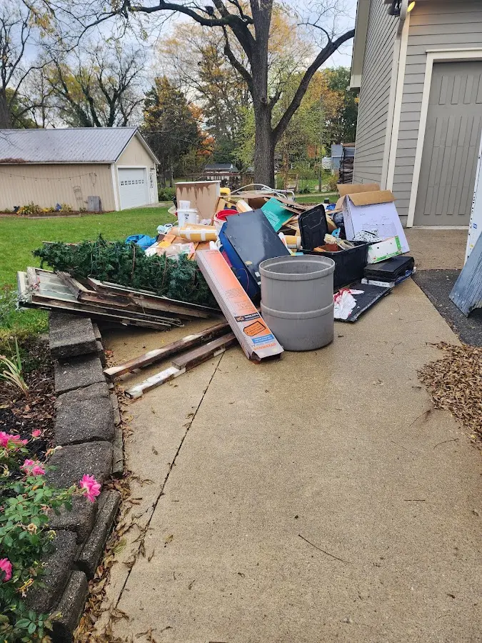 Dumpster being loaded with debris for 12 Yard Dumpster Rental in Parkville